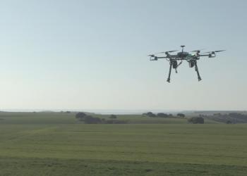 Drone flying on a field